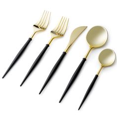 gold and black utensils are lined up on a white surface with one fork, the other two spoons