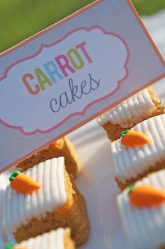 carrot cakes on a plate with a sign that says carrot cakes in the middle and small carrots at the top