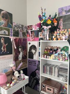 a room filled with lots of clutter and stuffed animals on top of bookshelves