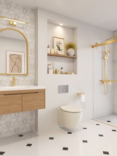 a bathroom with a toilet, sink, and shower in white and gold colors on the walls