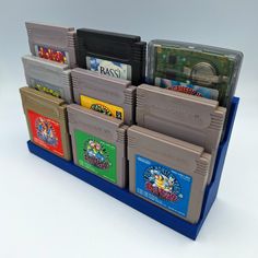 the nintendo gameboy's are stacked on top of each other in this display