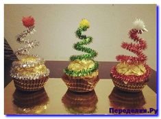 three small baskets with flowers in them on a table