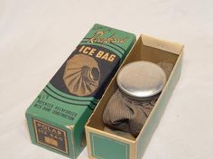 an old fashioned ice bag in a green box with a silver lid and tie on it