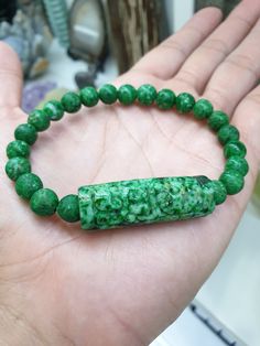 A rarity and collector's piece : old semi-baroque Maw Sit Sit beads bracelet, unpolished 8 mm size beads with speckled chrome green color, charmed with an old piece of carved Ruyi Jade cylinder (3.8 cm x 1.3 cm), FeiCui Type A natural Jadeite Jade (non-bleached, non-dyed, non-treated material). Both beads and charm are porous and will absorb the natural oils of your skin making them more vivid green in color; the same reason why they need to be rubbed with a a drop of mineral oil from time to ti Spiritual Carved Round Beads Bracelets, Spiritual Carved Round Beads Bracelet, Chrome Green, Beads Bracelet, Mineral Oil, Rarity, Bracelet Sizes, Natural Oils, Green Color