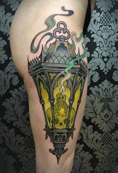 a man's leg with a tattoo on it and a street light in the background