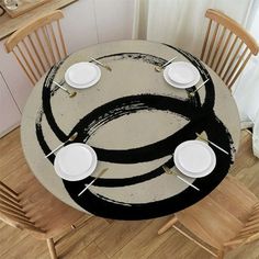 the table is set with white plates and place settings for four people to enjoy their meal