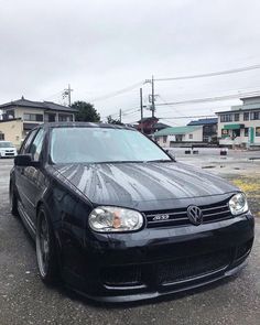 a black car parked in a parking lot