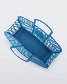 a blue plastic basket with handles on a white surface