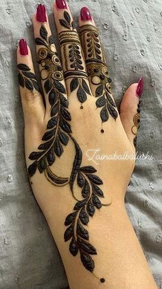 a woman's hand is decorated with hennap and flowers on it,