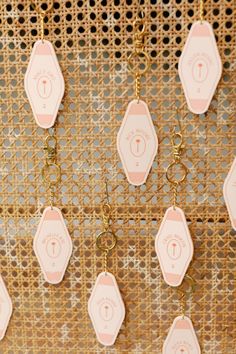 pink and gold key chains hanging from a wall