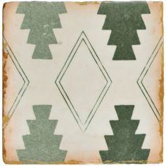 an old fashioned tile with green and white designs on the back side, in various shapes