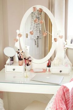 a desk with a mirror and makeup on it