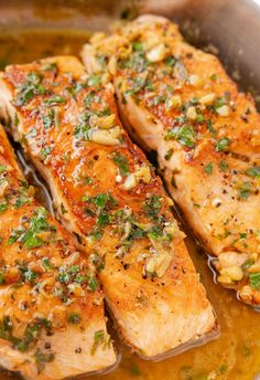 cooked salmon fillets in a pan with mustard and parsley on the side, ready to be eaten