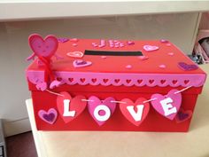 a valentine's day box is decorated with hearts and the word love on it