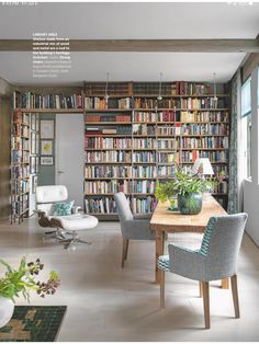 a room filled with lots of books and furniture