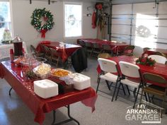 a room filled with tables and chairs covered in red tablecloths