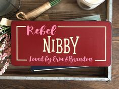 a personalized wooden box with flowers and other items on it that says, rebel nibby loved by erin & brandon