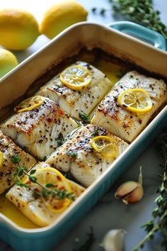 fish with lemons and herbs in a baking dish