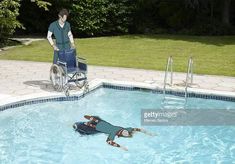 a man in a pool with a wheel chair