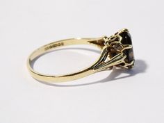 Here is a very nice 9ct yellow gold Smoky Quartz ring in a UK size O. 1/2 and US size approx 7. 1/2. The oval shaped facet cut smoky Quartz is claw set into an open backed mount. It is fully hallmarked for Sheffield 9ct gold, 1990, the makers mark is SJ. The stone measures approx 8.5mm x 6.5mm. The ring weighs 1.7 grams. It is in good condition with minimal age and use wear in the form of general wear, minor exterior wear. See pictures. A nice ring. Pics taken next to an English 1p coin. ------- Classic Gold Opal Ring Collectible, Classic Gold Opal Ring For Collectors, Gold Opal Ring Collectible Classic Style, Estate Gold Ring As Gift, Smokey Quartz Ring, Gold Ring Vintage, Smoky Quartz Ring, 3 Stone Rings, Twist Ring