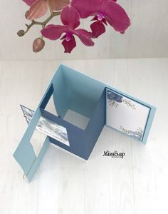 an open box with some flowers in it