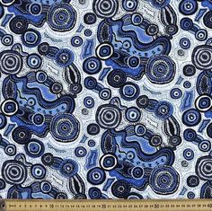 a blue and white fabric with swirls on the bottom, in an abstract pattern