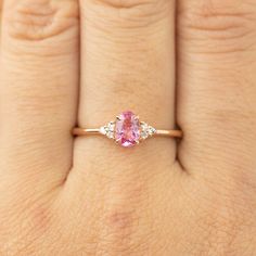 * ≈6x4mm Pink tourmaline * Side stones : White diamonds G color SI1 0.06ctw * Band width: ≈1.4mm Tapered band * 14k solid rose gold * Made of 100% recycled solid14k gold metal and ethically sourced gemstones Ring Size This ring is currently size 7, and can be resized 3~8.5 in 10 days. For other ring size, it is going to be a custom order. Please email cs@enverojewelry.com. Custom Order This ring can be made in any size, any material and different gemstone. For full details of semi-custom order, Oval Pink Diamond Ring For Proposal, Pink Oval Diamond Ring For Proposal, Dainty Pink Oval Ring, Diamond Ring Oval, Sapphire Earrings Studs, Unique Engagement Ring, Ring Oval, October Birthstone, Diamond Cluster Ring