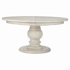 a white pedestal table with an oval top