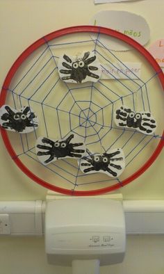 a paper plate with handprints on it in front of a white wall and red circle