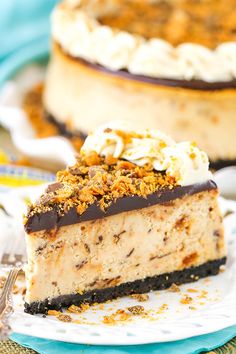 a piece of cheesecake on a white plate with a fork and another pie in the background