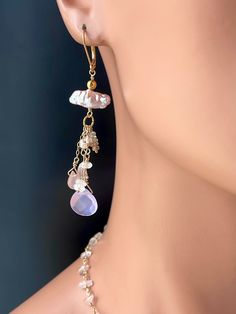 "Dangle drop gemstone earrings in delicate early morning pastel sunrise hues. Lavender, peach, gray heather, mauve, clear and gold are like balm for the soul. The show stopping faceted lavender quartz crystal briolettes are suspended from peach freshwater Biwa pearls and connected with gold filled wire. Other faceted gemstones mingle together such as chalcedonies, moonstones, tourmaline, and rose quartz. Gold plated latch back earwires.  Dimensions: 3\" long x .0.5\" wide Materials: gold plated Delicate Drop Earrings With Natural Stones, Delicate Natural Stone Drop Earrings, Delicate Pink Drop Jewelry, Pastel Dangle Jewelry For Gifts, Natural Stone Drop Earrings For Wedding, Drop Earrings With Natural Stones For Wedding, Pastel Drop Earrings Jewelry As Gift, Elegant Handmade Blush Jewelry, Elegant Pastel Jewelry Gift