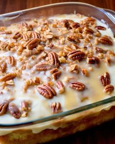 a casserole dish filled with cream and pecans