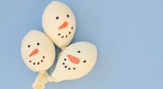 three white balloons shaped like snowmen on a blue background with one balloon attached to the other