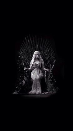 a woman standing on top of a iron throne