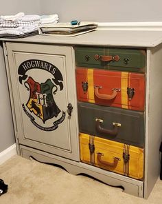 a harry potter dresser with many suitcases on it's doors and drawers, all painted in different colors