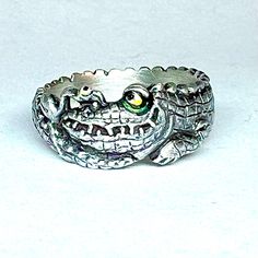 From the "Todd Warner & Link Wachler Sculpture Jewelry" Collection. Oxidized sterling silver handmade ring by International Award Winning jewelry Designer, Link Wachler. 3/8" wide at the top of the ring and 1/4" wide at the bottom. Made to fit finger size. Hand-colored eyes with epoxy resin. Custom one-of-a-kind jewelry designs available. Gold, platinum and bronze also available. Please contact Link Wachler with any questions. This ring design is inspired by sculptor, Todd Warner's classic paint Alligator Ring, Ceramic Alligator, Lizard Ring, Silver Bird Ring, Sculpture Jewelry, Bird Ring, Bird Rings, Vintage Fish-shaped Collectible Jewelry, Award Winning Jewelry