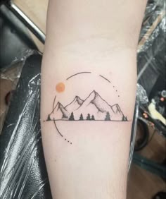 a mountain tattoo on the arm