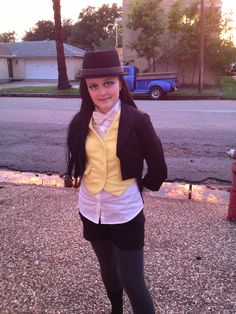 a young woman is dressed up and posing for the camera in front of a fire hydrant