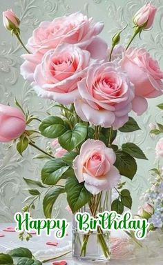 a vase filled with pink roses on top of a table