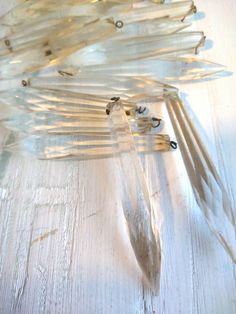 an image of a clock made out of glass sticks and wire on a table top