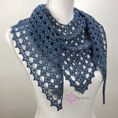 a blue crocheted shawl on top of a mannequin