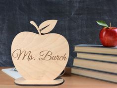 an apple sitting on top of a pile of books