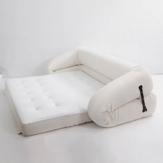 an inflatable bed sitting on top of a white floor next to a wall