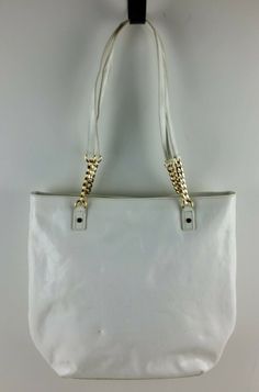 Michael Kors MK Signature Patent Leather Tote Shoulder Handbag Purse White.  Pre-owned condition.  This bag has some spots/marks on the back.  The patent is stiff and the handles are starting to crack.  The inside liner is clean and in good condition.  Please see photos for detailed condition. Store Policies General Please review the listing description and photos carefully.  We try our best to identify and describe condition issues and provide measurements if relevant.  If you have any question Michael Kors Large Capacity Shoulder Bag, Michael Kors Large Capacity Shoulder Bag For Daily Use, Purse White, Shoulder Handbag, Handbag Purse, Shoulder Handbags, Leather Tote, Patent Leather, Handles