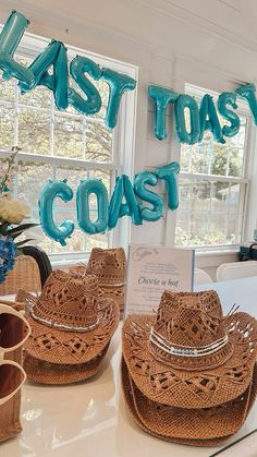 some hats are sitting on a table in front of a sign that says last toast