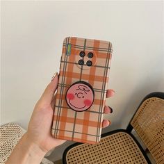 a person holding up a phone case with a pig on it