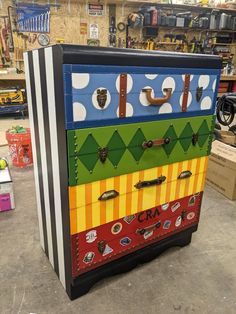 a multicolored chest with lots of knobs on it in a shop setting