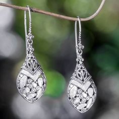 Gleaming sterling silver highlights the uniquely Indonesian style of these dangle earrings designed by artisan Kadek Hendra. The earrings take the shape of a buli-buli or bottle. .925 Sterling silver Unique Silver Dangle Teardrop Earrings, Unique Silver Teardrop Dangle Earrings, Silver Teardrop Earrings With Oxidized Finish As Gift, Sterling Silver Teardrop Earrings With Oxidized Finish, Elegant White Oxidized Finish Earrings, Silver Highlights, Blue Topaz Earrings, Silver Dangle Earrings, Sterling Silver Cuff Bracelet