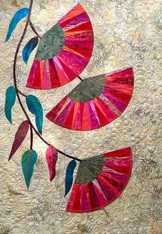 a quilted wall hanging with colorful leaves on it's sides and one branch