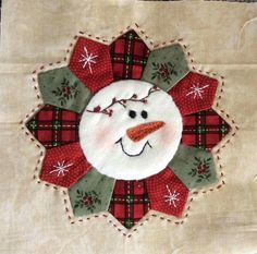 a close up of a snowman's face on a piece of cloth